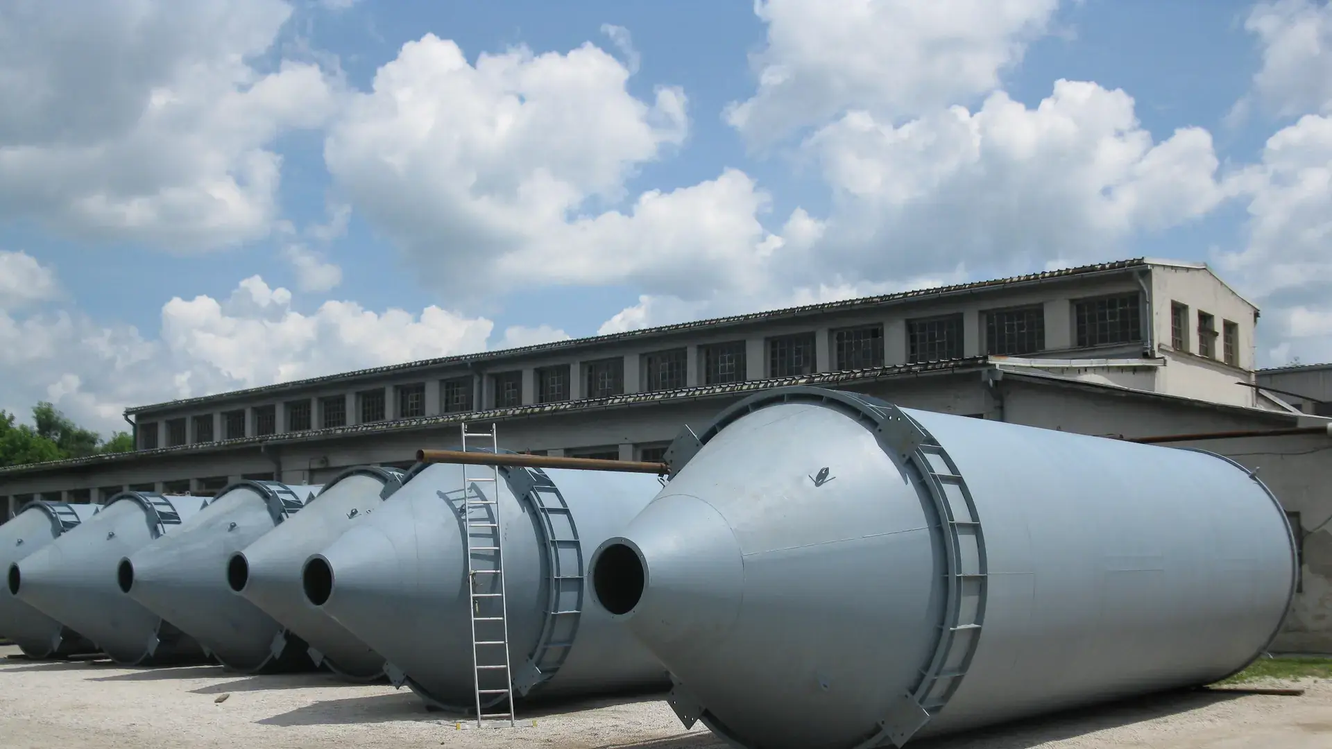 A series of cyclones ready for dispatch in front of the plant